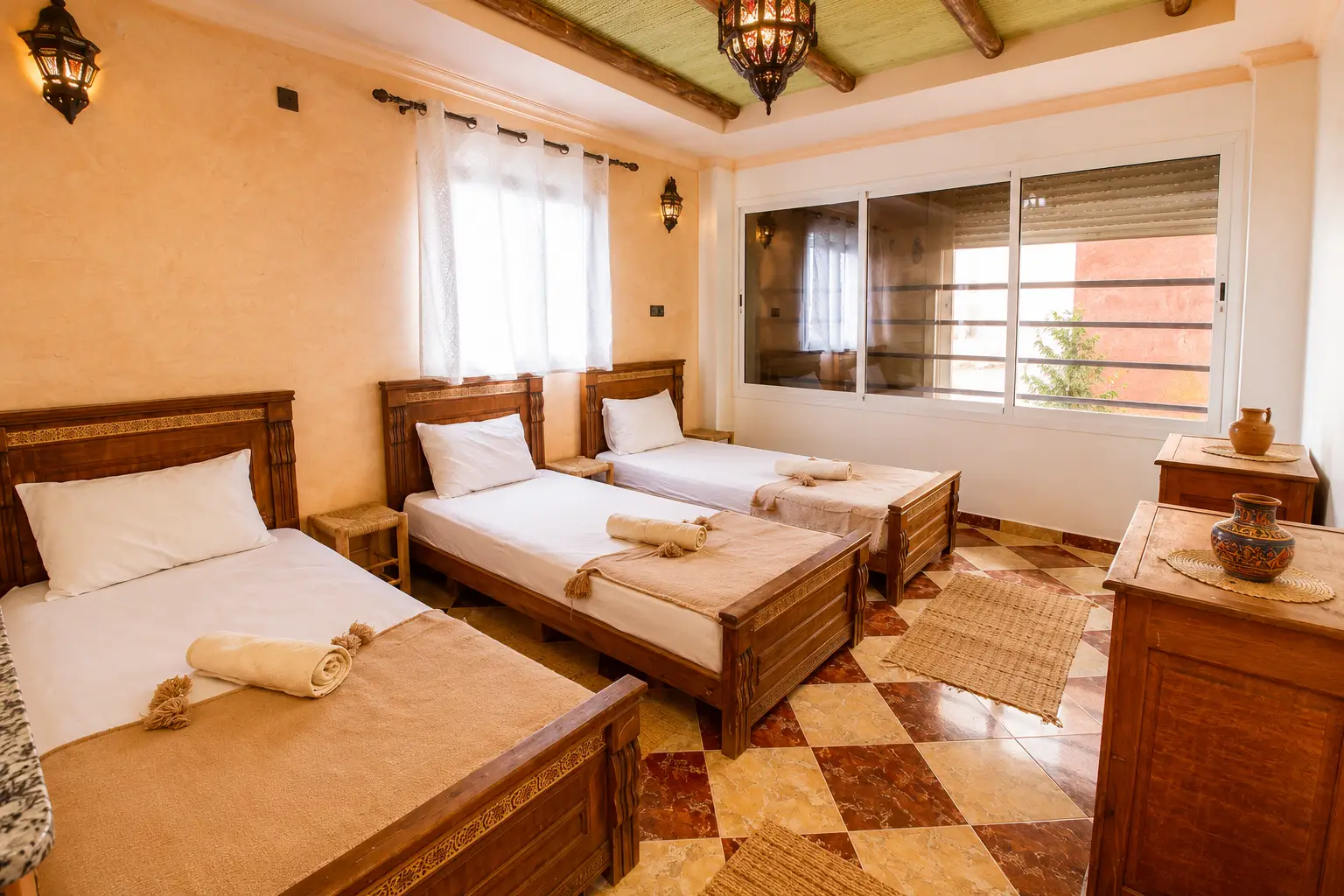 Shared triple room with three single beds at a surf camp in Morocco